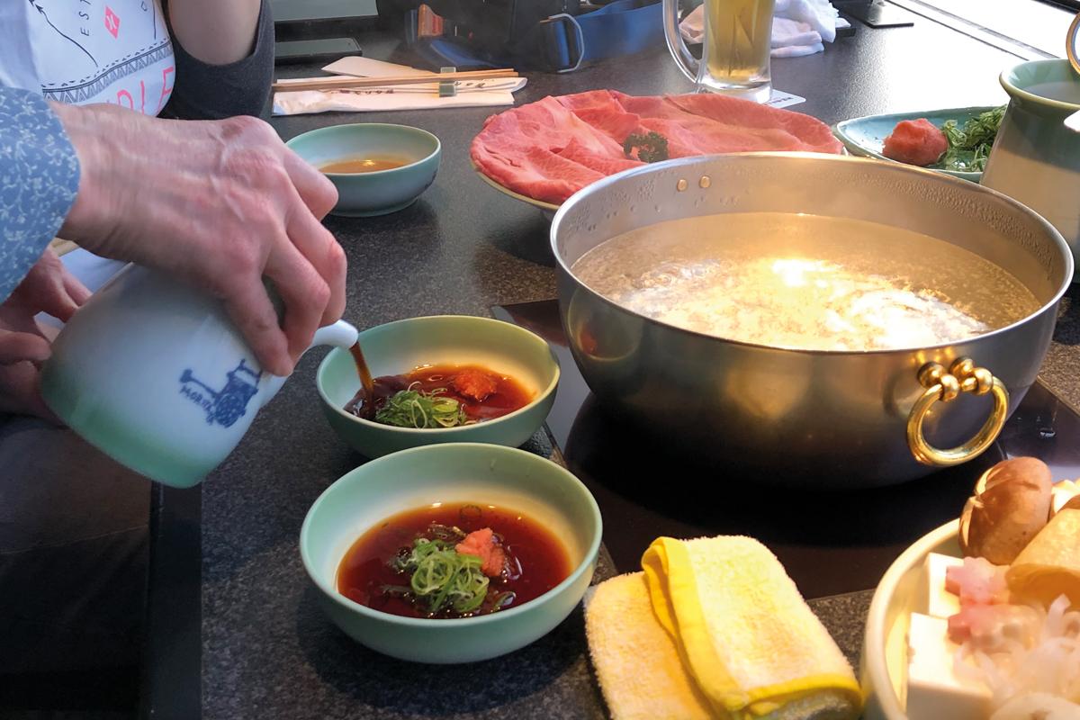 Pouring ponzu sauce for Shabu-Shabu dinner
