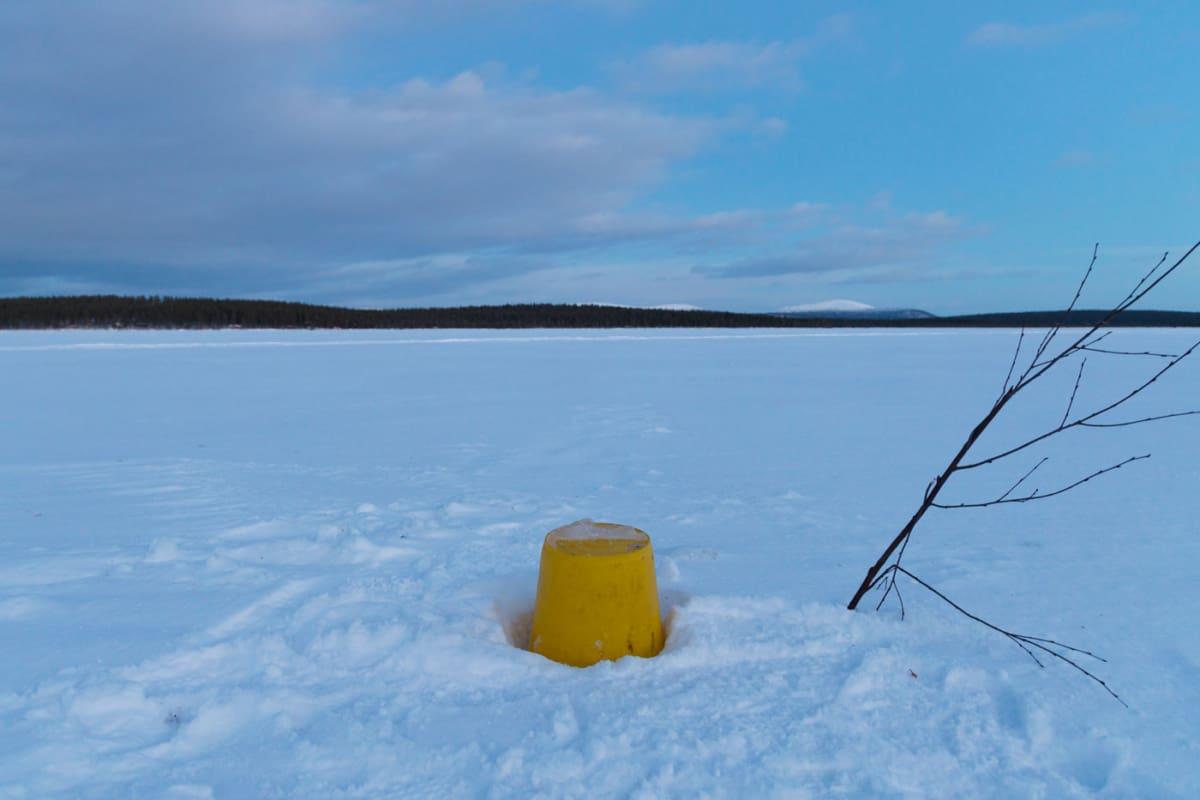 A bucket marks the hole in the river to fetch water