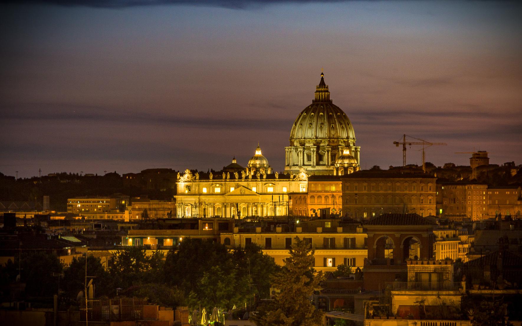 View over Piazza del Popolo towards St. Peter's Basilica at night.
